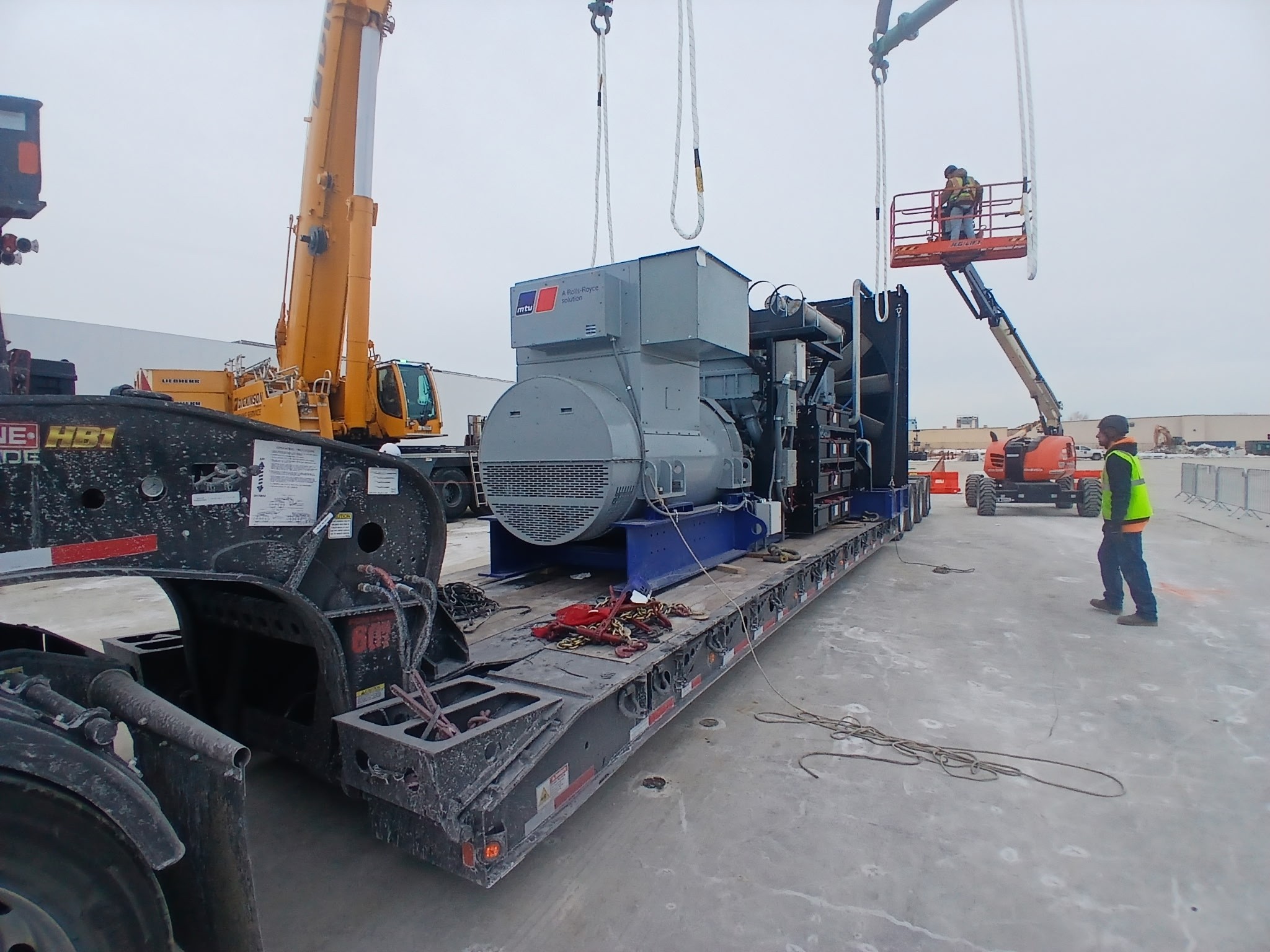 Large generator being transported on a heavy haul flatbed truck